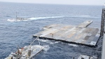 This undated photo released early Tuesday, April 30, 2024, by the U.S. military's Central Command shows construction off a floating pier in the Mediterranean Sea off the Gaza Strip. (U.S. military's Central Command via AP) 