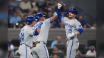 Kansas City Royals' Michael Massey (19) celebrates with teammates Salvador Perez (13) and Freddy Fermin (34) after hitting a two-run home run during second inning American League MLB baseball action in Toronto on Tuesday, April 30, 2024. THE CANADIAN PRESS/Nathan Denette