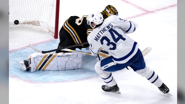 Toronto Maple Leafs centre Auston Matthews (34) beats Boston Bruins goaltender Linus Ullmark, back, for a goal during the third period of Game 2 of an NHL hockey Stanley Cup first-round playoff series, Monday, April 22, 2024, in Boston. THE CANADIAN PRESS/AP-Charles Krupa