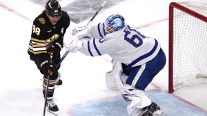Toronto Maple Leafs goaltender Joseph Woll (60) stops Boston Bruins right wing David Pastrnak (88) during the third period of Game 5 of an NHL hockey Stanley Cup first-round playoff series, Tuesday, April 30, 2024, in Boston. THE CANADIAN PRESS/AP/Charles Krupa