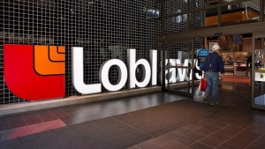 Grocery and drugstore retailer Loblaw Cos. Ltd. raised its quarterly dividend by 15 per cent as it reported its first-quarter profit and revenue rose compared with a year ago. A Loblaws store is shown in Toronto on Thursday May 2, 2013. THE CANADIAN PRESS/Aaron Vincent Elkaim