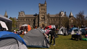 Pro-Palestinian protesters talk at an encampment set up on the University of Toronto campus on Thursday, May 2, 2024. THE CANADIAN PRESS/Chris Young