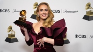 FILE - Adele, winner of the award for best pop solo performance for "Easy on Me," poses in the press room at the 65th annual Grammy Awards on Feb. 5, 2023, in Los Angeles. Artists from Universal Music Group, which include Drake, Adele, Bad Bunny and Billie Eilish, will be returning to TikTok as the two parties have struck a new licensing agreement following an approximately three-month long dispute. (AP Photo/Jae C. Hong, File)