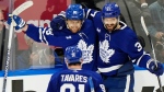Toronto Maple Leafs' William Nylander (88) celebrates his goal against the Boston Bruins with John Tavares (91) and Timothy Liljegren (37) during second period action in Game 6 of an NHL hockey Stanley Cup first-round playoff series in Toronto on Thursday, May 2, 2024. THE CANADIAN PRESS/Frank Gunn