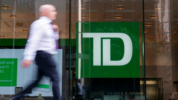 A person makes their way past a Toronto-Dominion Bank in the Financial District of Toronto on August 14, 2023. THE CANADIAN PRESS/Spencer Colby
