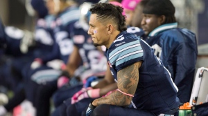 FILE - Toronto Argonauts slotback Chad Owens (2) sits on the bench during second half CFL football action against the Montreal Alouettes in Hamilton, Ontario on Friday, October 23, 2015. THE CANADIAN PRESS/Peter Power 