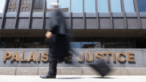 A Quebec court judge will decide whether the province's new language reform is constitutional, because a section of the law systematically delays the delivery of English verdicts. A lawyer walks past the courthouse in Montreal, Wednesday, July 12, 2023. THE CANADIAN PRESS/Christinne Muschi

