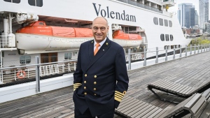 Rens Van Eerten, captain of the Volendam cruise ship, poses alongside the ship in the Port of Montreal, Saturday, May 4, 2024. The cruise ship is the first to arrive in the port this year and housed 1,500 Ukrainian refugees for several months in 2022. THE CANADIAN PRESS/Graham Hughes