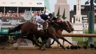 Sierra Leone, with jockey Tyler Gaffalione, (2), Forever Young, with jockey Ryusei Sakai, and Mystik, with jockey Dan Brian Hernandez Jr., cross finish line at Churchill Downs during the 150th running of the Kentucky Derby horse race Saturday, May 4, 2024, in Louisville, Ky. (AP Photo/Kiichiro Sato)