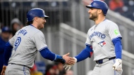 Toronto Blue Jays' Kevin Kiermaier, right, celebrates with Danny Jansen, left, after hitting a two-run home run during the eighth inning of a baseball game against the Washington Nationals, Saturday, May 4, 2024, in Washington. (AP Photo/Nick Wass)