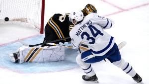 Toronto Maple Leafs centre Auston Matthews (34) beats Boston Bruins goaltender Linus Ullmark, back, for a goal during the third period of Game 2 of an NHL hockey Stanley Cup first-round playoff series, in Boston, Monday, April 22, 2024. THE CANADIAN PRESS/AP-Charles Krupa