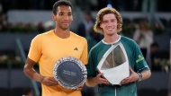 Andrey Rublev, of Russia, right, holds his trophy after winning against Felix Auger-Aliassime, of Canada, left, in the Madrid Open men's final match in Madrid, Spain, Sunday, May 5, 2024. (AP Photo/Manu Fernandez)