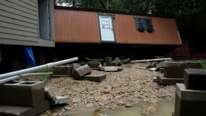 Dorothy and Earl Blevins' temporary home sits off its foundation after it was moved by flooded water and into the new home they are building on property once owned by Dorothy's mother on Sunday, May 5, 2024, in Spendora, Texas.  (Elizabeth Conley/Houston Chronicle via AP)