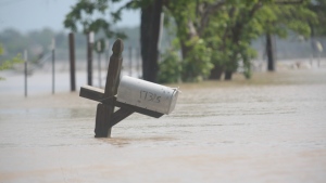 A mailbox is partially submerged on a flooded street in an unincorporated area in east Harris County near Houston on Sunday morning, May 5, 2024. (AP Photo/Lekan Oyekanmi)