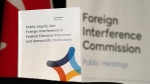 A copy of the interim report is seen on a table following its release at the Public Inquiry Into Foreign Interference in Federal Electoral Processes and Democratic Institutions, in Ottawa, Friday, May 3, 2024. THE CANADIAN PRESS/Adrian Wyld