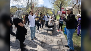 Palestinian supporters try to block an Israeli supporter, right, at the encampment on McGill University campus Monday, May 6, 2024, in Montreal. THE CANADIAN PRESS/Ryan Remiorz