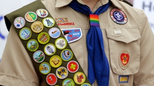 Merit badges and a rainbow-coloured neckerchief slider are affixed on a Boy Scout uniform outside the headquarters of Amazon in Seattle.  (AP Photo/Ted S. Warren, File)