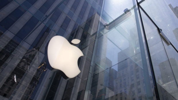 FILE - In this June 16, 2020 file photo, the sun is reflected on Apple's Fifth Avenue store in New York. Apple will reports earnings on Thursday May 2, 2024. (AP Photo/Mark Lennihan, File)