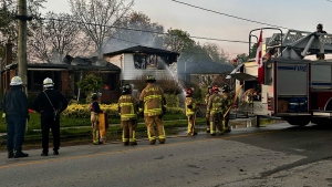 Firefighters douse a home which caught fire on Bridge Road in Oakville Thursday May 9, 2024. (Michael Nguyen /CP24)