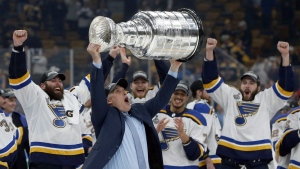 St. Louis Blues head coach Craig Berube hoists the Stanley Cup after the Blues defeated the Boston Bruins in Game 7 of the NHL Stanley Cup Final, Wednesday, June 12, 2019, in Boston. THE CANADIAN PRESS/AP/Michael Dwyer