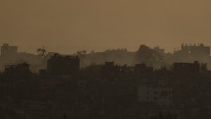 Destroyed buildings in the Gaza Strip are seen during the sunset from southern Israel, Thursday, May 9, 2024. (AP Photo/Leo Correa)