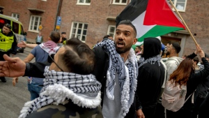 Protesters try to get past a police cordon are held back by fellow demonstrators during a demonstration against Israel's participation in Eurovision in Malmö, Thursday, May 9, 2024. Israel participates in the second semi-final of the song competition on Thursday. (Ida Marie Odgaard/Ritzau Scanpix)