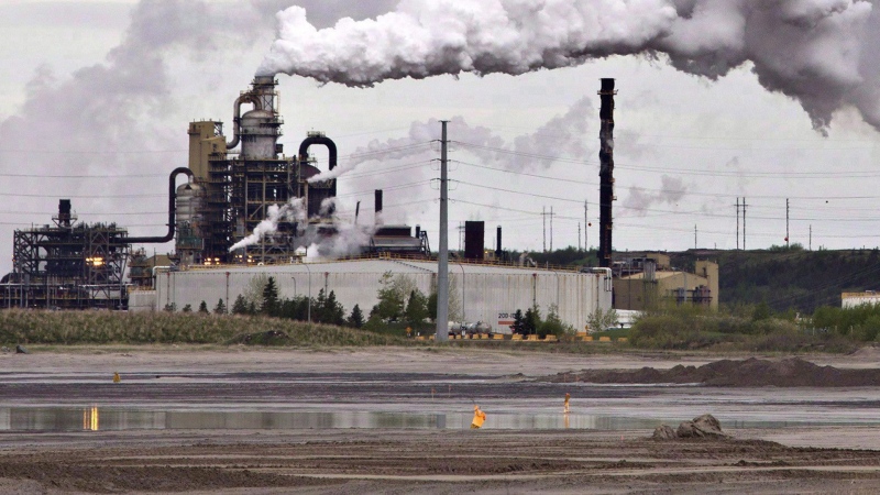By betting that it can solve its emissions problem with carbon capture and storage technology, Canada's oil and gas industry risks sadding itself with expensive stranded assets, a new report argues. A dump truck works near the Syncrude oil sands extraction facility near the city of Fort McMurray, Alberta on Sunday June 1, 2014. THE CANADIAN PRESS/Jason Franson
