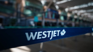 A WestJet logo is seen in the domestic check-in area at Vancouver International Airport, in Richmond, B.C., on Friday, May 19, 2023. THE CANADIAN PRESS/Darryl Dyck