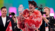 Nemo of Switzerland, who performed the song The Code, celebrates after winning the Grand Final of the Eurovision Song Contest in Malmo, Sweden, Saturday, May 11, 2024. (AP Photo/Martin Meissner) 