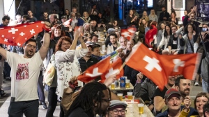 Supporters of singer Nemo, finalist of the 68th Eurovision Song Contest ESC, celebrate during a public viewing watching the broadcast of the ESC finals as Nemo is declared winner of the competition, in the early hours of Sunday, May 12, 2024, in Biel, Switzerland. (Adrian Reusser/Keystone via AP)