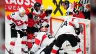 Austria's Paul Haber, back right, scores his sides first goal during the preliminary round match between Austria and Switzerland at the Ice Hockey World Championships in Prague, Czech Republic, Sunday, May 12, 2024. (AP Photo/Petr David Josek)