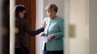 FILE - German Chancellor Angela Merkel, right, talks to her office manager Beate Baumann, left, prior to a cabinet meeting as part of a two-day retreat of the German government in Meseberg north of Berlin, Germany, Wednesday, May 25, 2016. Former German Chancellor Angela Merkel's memoirs will be released in late November, nearly three years after the end of her 16-year tenure at the helm of one of Europe's biggest powers, her publisher said Monday, May 13, 2024. (AP Photo/Michael Sohn, File)