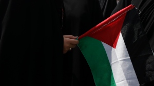 FILE: A demonstrator holds a Palestinian flag during the annual Al-Quds, or Jerusalem, Day rally in Tehran, Iran, Friday, May 7, 2021. (Vahid Salemi / The Associated Press)
