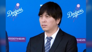 FILE - Interpreter Ippei Mizuhara listens during a baseball news conference at Dodger Stadium, Thursday, Dec. 14, 2023, in Los Angeles. Mizuhara, the former interpreter for Los Angeles Dodgers star Shohei Ohtani, is expected to plead not guilty Tuesday, May 14, 2024, to bank and tax fraud, a formality ahead of a deal he has negotiated with federal prosecutors in a sports betting case. (AP Photo/Marcio Jose Sanchez, File)