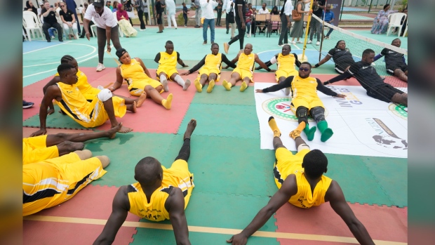 Peacemaker Azuegbulam, 27, Africa's first gold medalist at the Invictus Games, center left, warms up before an exhibition sitting volleyball match in Abuja, Nigeria, Saturday, May 11, 2024. He was among the soldiers deployed during Nigeria's grinding counter-offensive against Islamic extremists in the northeastern Borno state in 2020 when an anti-aircraft weapon was fired at them. By the time he regained consciousness, his life was no longer the same, starting with his left leg which was later amputated. (AP Photo/Sunday Alamba)