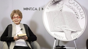 Nobel Prize-winning Canadian author Alice Munro reads from her book "The View From Castle Rock" at a ceremony held by the Royal Canadian Mint to celebrate her win where they unveiled a 99.99% pure silver five-dollar coin at the Great Victoria Public Library in Victoria, B.C., on March 24, 2014. THE CANADIAN PRESS/Chad Hipolito
