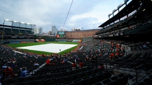 FILE - A tarp covers the infield at Oriole Park at Camden Yards prior to a scheduled baseball game between the Baltimore Orioles and the Toronto Blue Jays, Thursday, Aug. 24, 2023, in Baltimore. (AP Photo/Julio Cortez) 