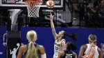 Indiana Fever guard Caitlin Clark (22) scores her first basket against the Connecticut Sun during the second quarter of a WNBA basketball game, Tuesday, May 14, 2024, in Uncasville, Conn. (AP Photo/Jessica Hill)