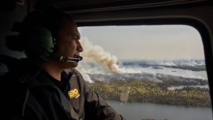 Manitoba Premier Wab Kinew surveys wildfires burning in northern Manitoba from a helicopter on Tuesday, May 14, 2024. THE CANADIAN PRESS/David Lipnowski