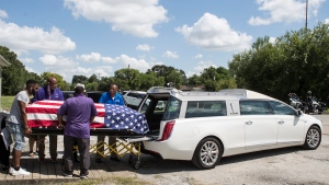 The body of New Orleans Police detective Everett Briscoe is placed into a hearse before it is escorted from the Respect for Life Funeral Home for the journey back to New Orleans, Tuesday, Aug. 24, 2021, in Houston. (Brett Coomer/Houston Chronicle via AP)