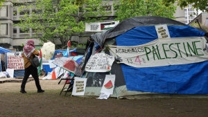 A person walks past the pro-Palestinian encampment on McGill University campus, in Montreal on May 13, 2024. THE CANADIAN PRESS/Ryan Remiorz