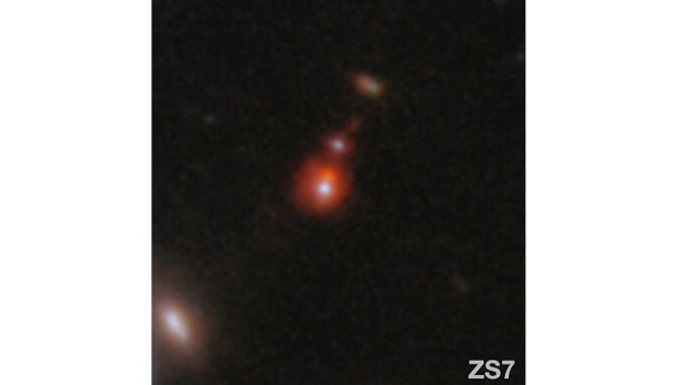 This image released by NASA shows the ZS7 galaxy system, revealing the ionized hydrogen emission in orange and the doubly ionized oxygen emission in dark red. (ESA/Webb, NASA via AP)