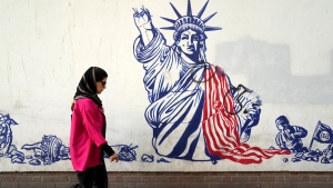 A woman passes an anti-American mural on the wall of the former U.S Embassy in Tehran, Iran, on Aug. 19, 2023. (Vahid Salemi / AP Photo) 