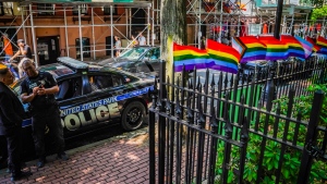 Pride flags decorate the fence at the Stonewall National Monument with U.S. Park police present on June 13, 2023 in New York. (Bebeto Matthews / AP Photo) 