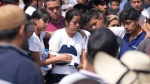 Relatives of a man slain in a mass shooting, attend a burial service in Huitzilac, Tuesday, May 14, 2024. The shooting in the mountain township beset by crime just south of Mexico City resulted in several deaths, authorities said Sunday. (AP Photo/Fernando Llano)