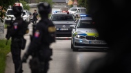 Policemen guard the area as convoy brings the suspect, in shooting of Slovakia's Prime Minister Robert Fico, to court in Pezinok, Slovakia, Saturday, May 18, 2024. Officials in Slovakia say Prime Minister Robert Fico has undergone another operation two days after his assassination attempt and remains in serious condition. (AP Photo/Tomas Benedikovic)
