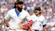 Toronto Blue Jays pitcher Kevin Gausman, right, celebrates as he walks off the mound at the end of the top of fifth inning MLB baseball action against the Tampa Bay Rays, in Toronto, Saturday, May 18, 2024. THE CANADIAN PRESS/Chris Young 