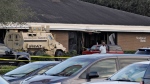 A Highlands County Sheriff's SWAT vehicle is stationed out in front of a SunTrust Bank branch, Wednesday, Jan. 23, 2019, in Sebring, Fla., where authorities say five people were shot and killed.  (AP Photo/Chris O'Meara, File)