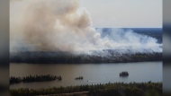 As more Canadians grapple with catastrophic impacts from climate-fuelled extreme weather, from wildfires to deadly heat waves, the question of how a person can keep up the fight for planetary health while tending to their mental health has extended beyond the environmental movement and become more urgent and widespread. A wildfire burns in northern Manitoba near Flin Flon, as seen from a helicopter surveying the situation, Tuesday, May 14, 2024. THE CANADIAN PRESS/David Lipnowski