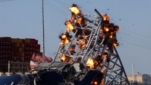 Explosives are detonated to free the container ship Dali after it was trapped following its collision with the Francis Scott Key Bridge. (Leah Millis / Reuters)